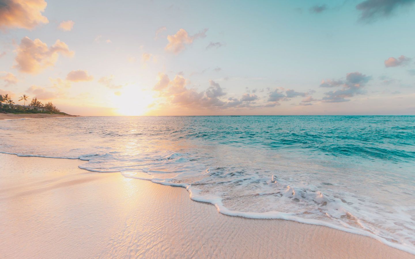 a beach at sunset with bright blue water and pink sand